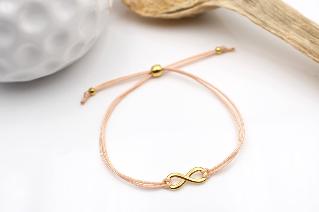Makramee Armband Damen mit Unendlichkeitszeichen und verstellbarem Kugel Verschluss in gold