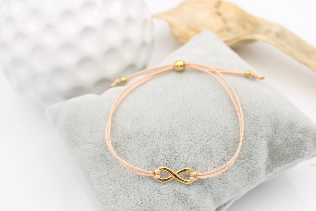 Infinity Armband in pfirsich mit Kugelverschluss in gold