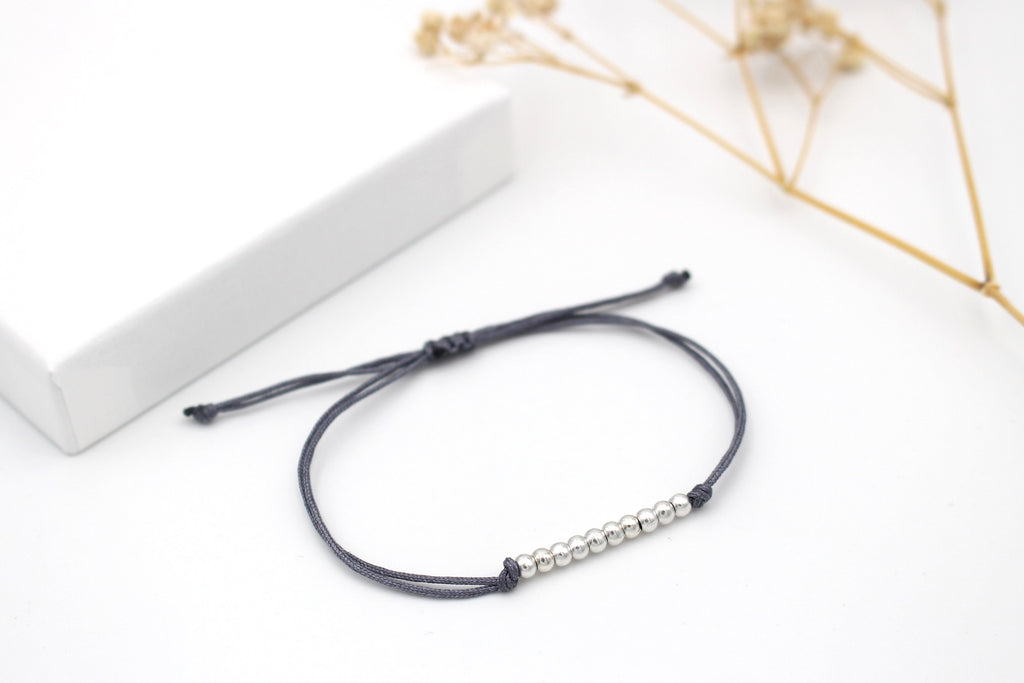 dunkel graues Makramee Armband mit 10 kleinen Perlen in der Mitte