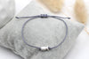 graues Makramee Armband mit silbernem Ichthys Fisch als Symbol und einem geflochtenen Makramee Verschluss