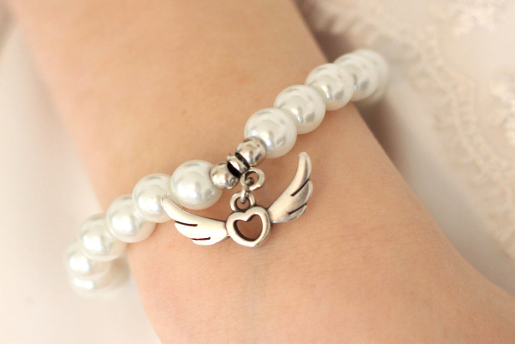 weißes Armband zur Kommunion und Taufe als Geschenk für Mädchen mit Engelsflügel Anhänger