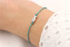 aquamarin farbenes Makramee Armband Fisch silber am Handgelenk 