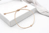 beiges Makramee Armband mit einer Perle und Herz Anhänger rosegold