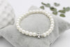 Ivory farbenes Perlenarmband Kreuz zur Jugendweihe